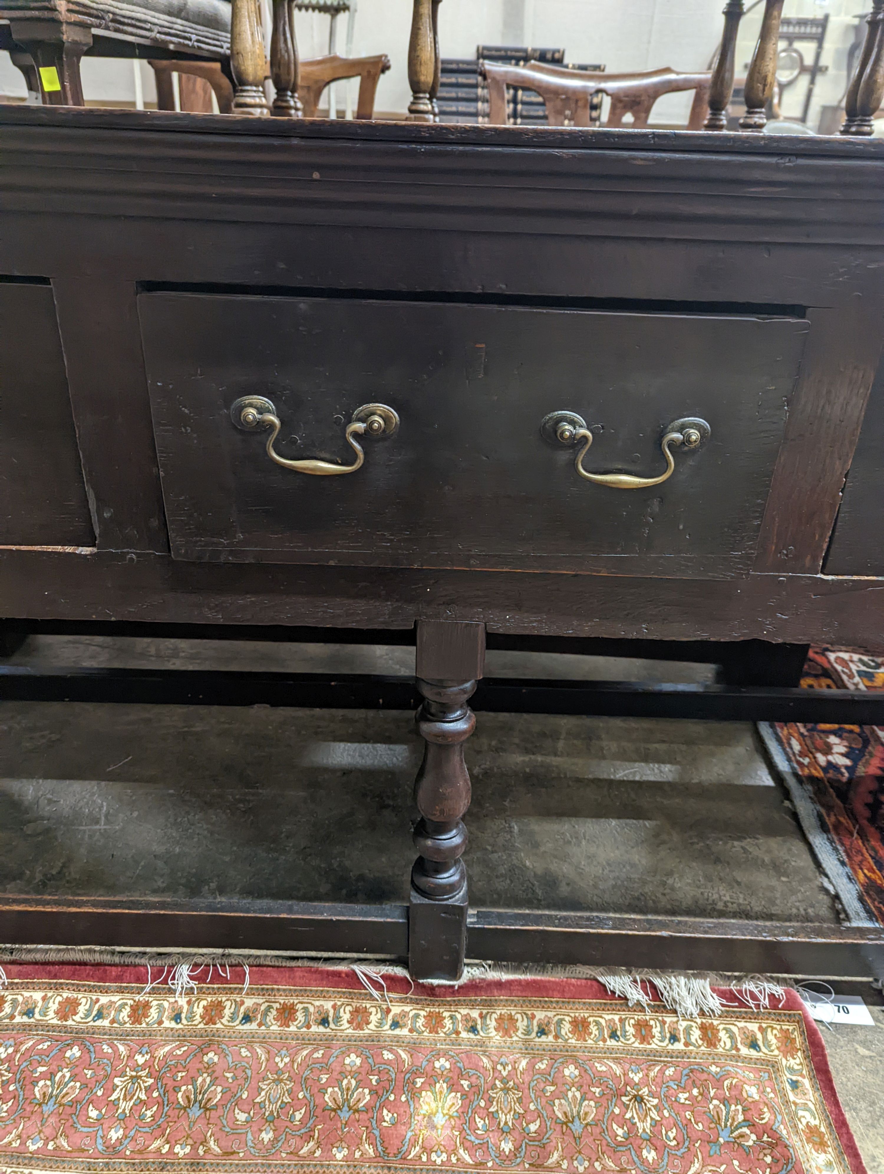 A George III oak low dresser base, length 175cm, depth 51cm, height 82cm